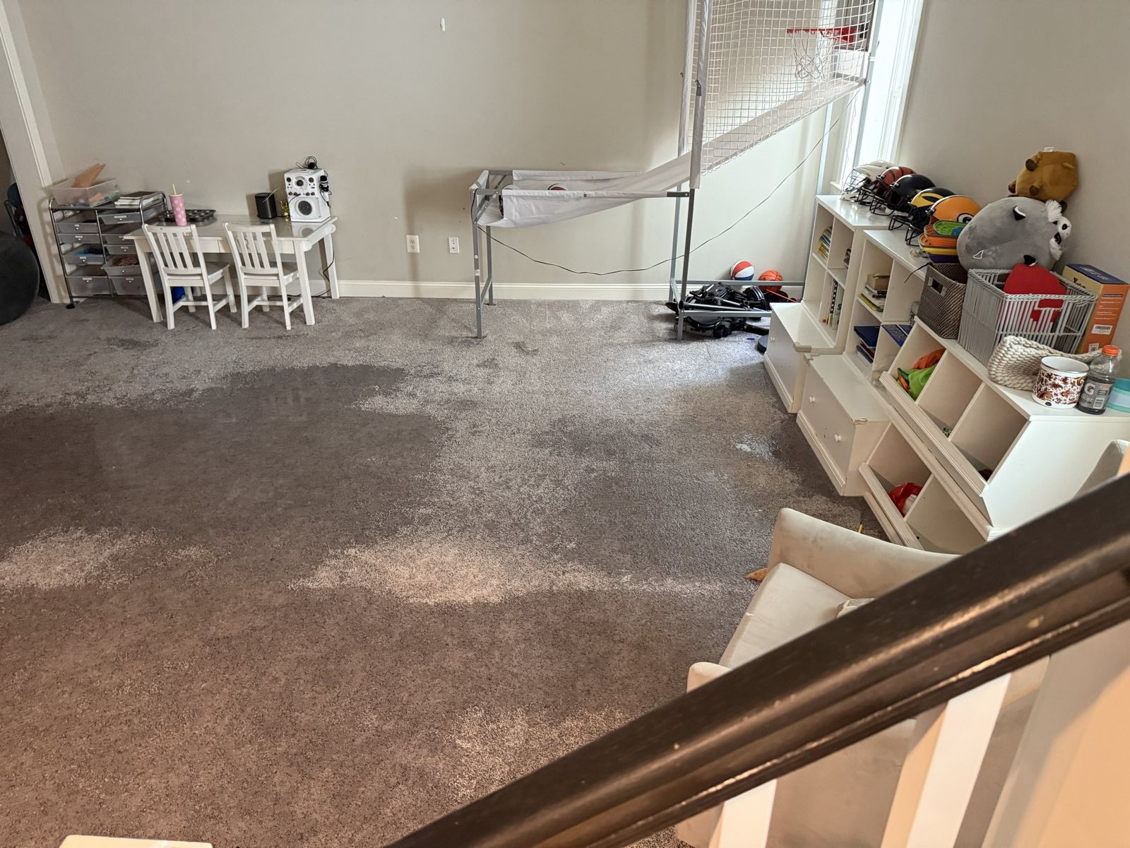 Water-soaked carpet in a finished ground-floor room before extraction and structural drying